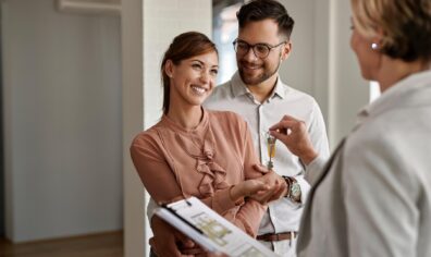 Couple getting keys for a house from agent