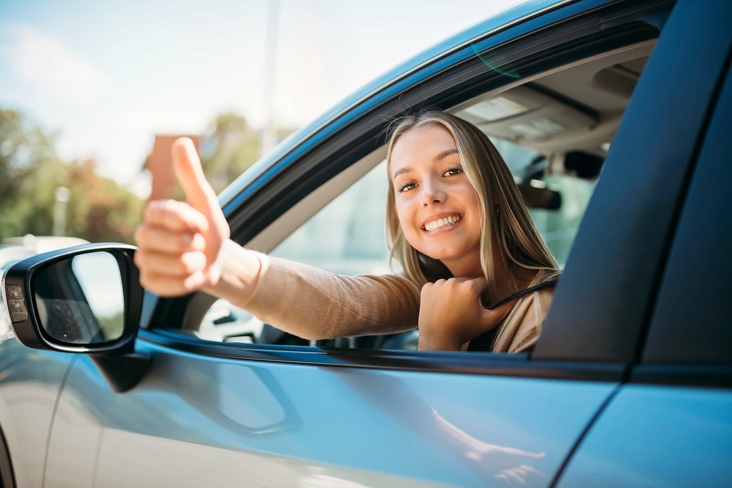 woman happy owner of new car