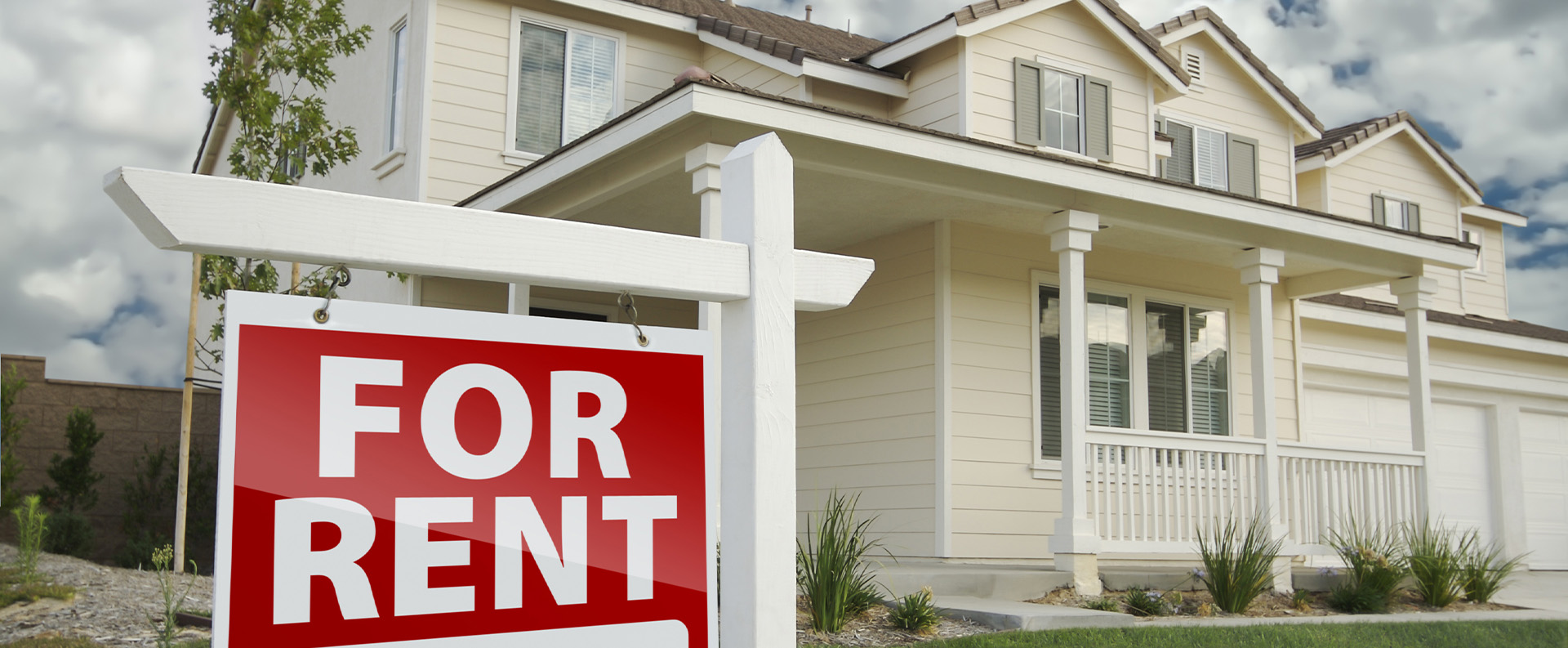 A For Rent sign on the lawn of a two-storey Ontario rental home